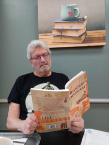 Photo of happy reader, George Buddy with a copy of the book 'A Reluctant Aristocrat' by Guy Mackenzie.